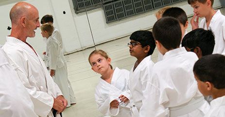 Instructor teaching lecturing students on martial arts
